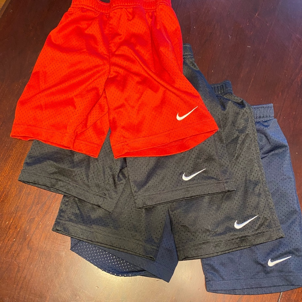 Sold together!  Set of 4.  2 black, one blue, one red.  Boys Nike shorts.